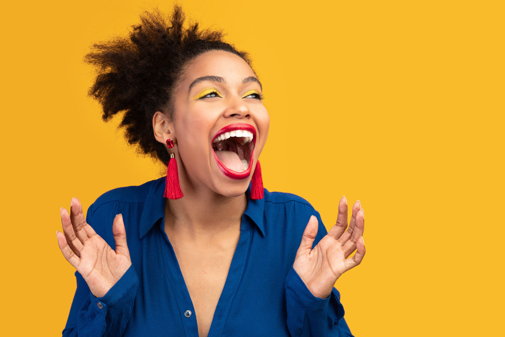 Expressive Woman Smiling and Laughing in Joy Yellow