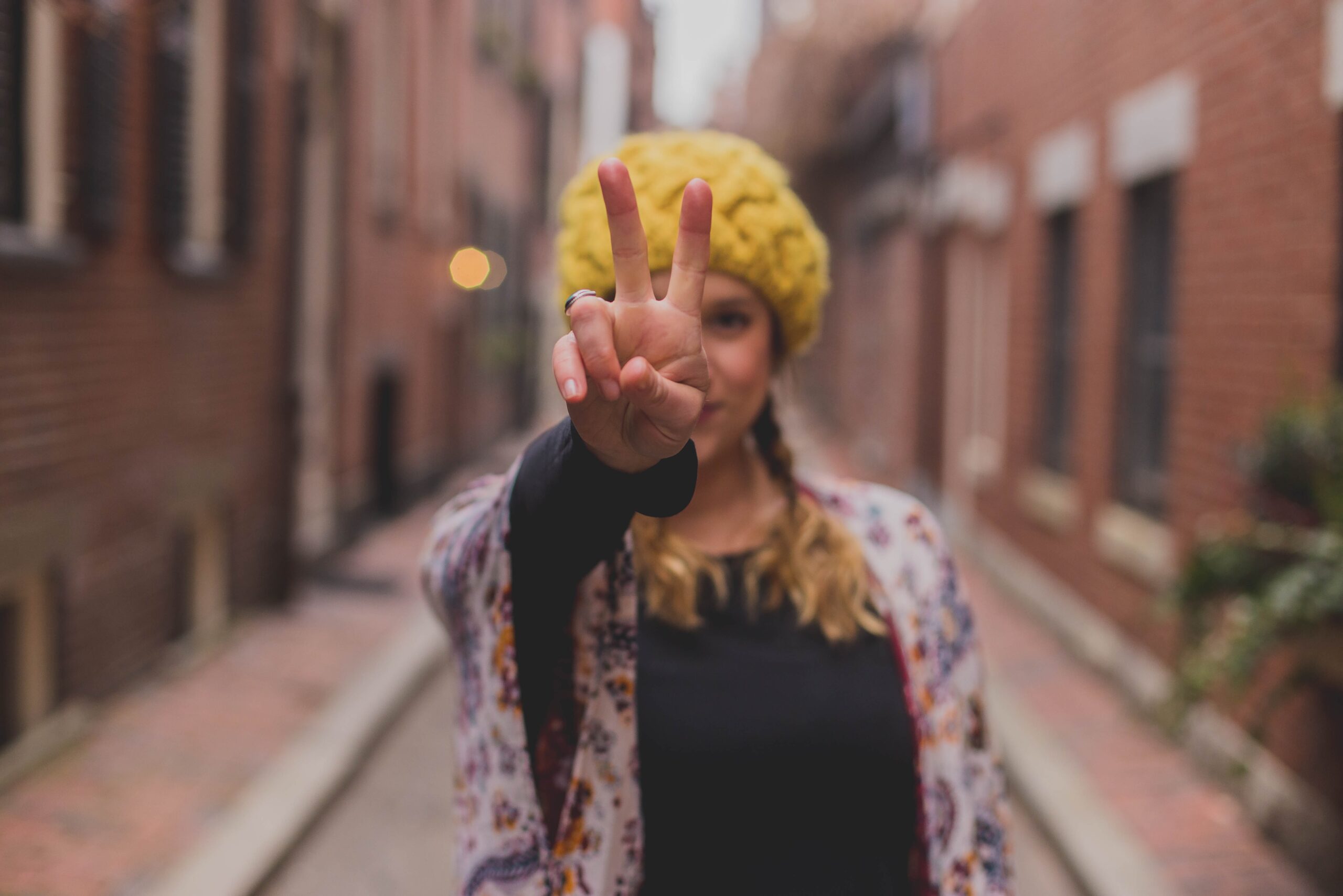 Woman holding up a peace sign